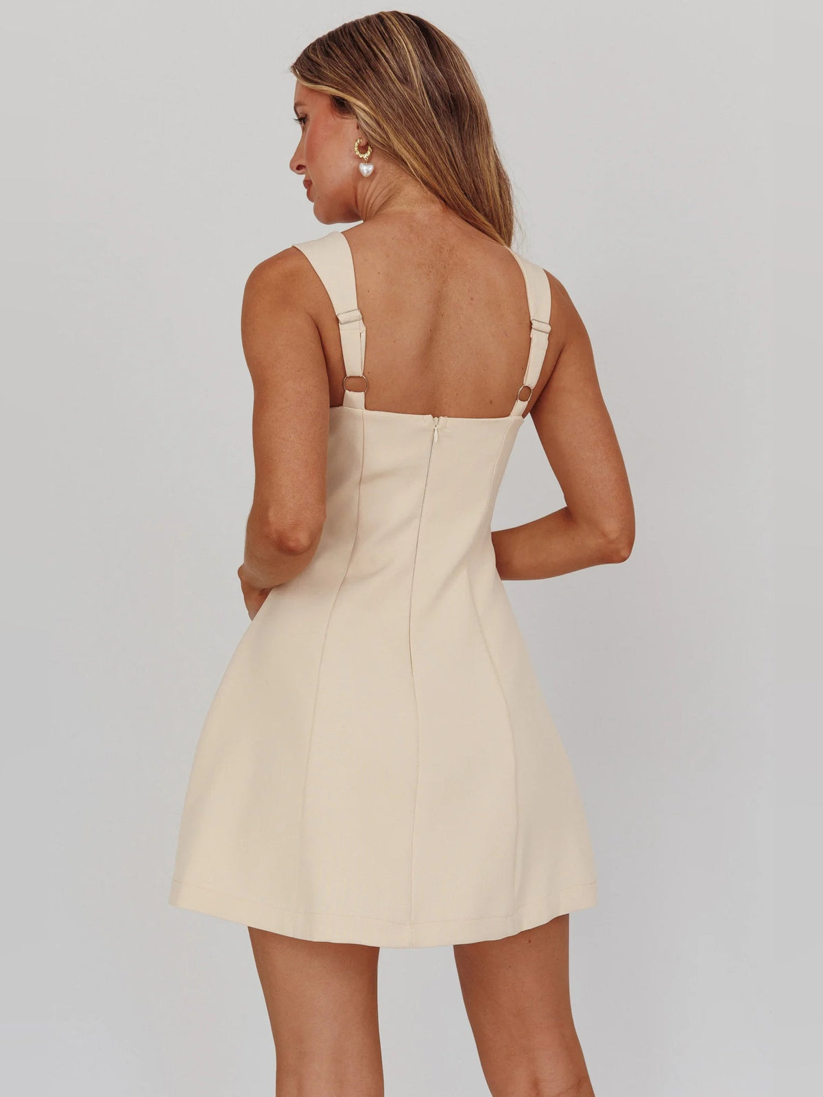 Back view of apricot A-line mini dress with square back and thin straps