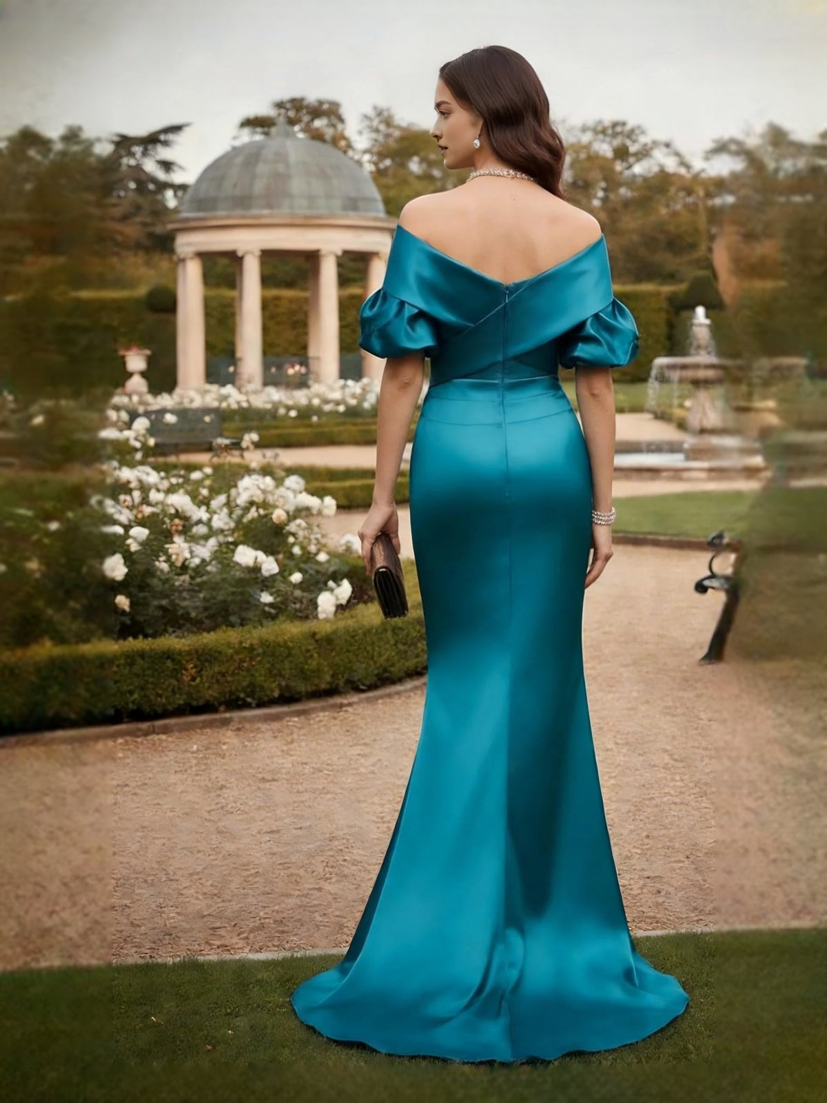 Back view of teal satin mermaid maxi dress with off-shoulder draped neckline