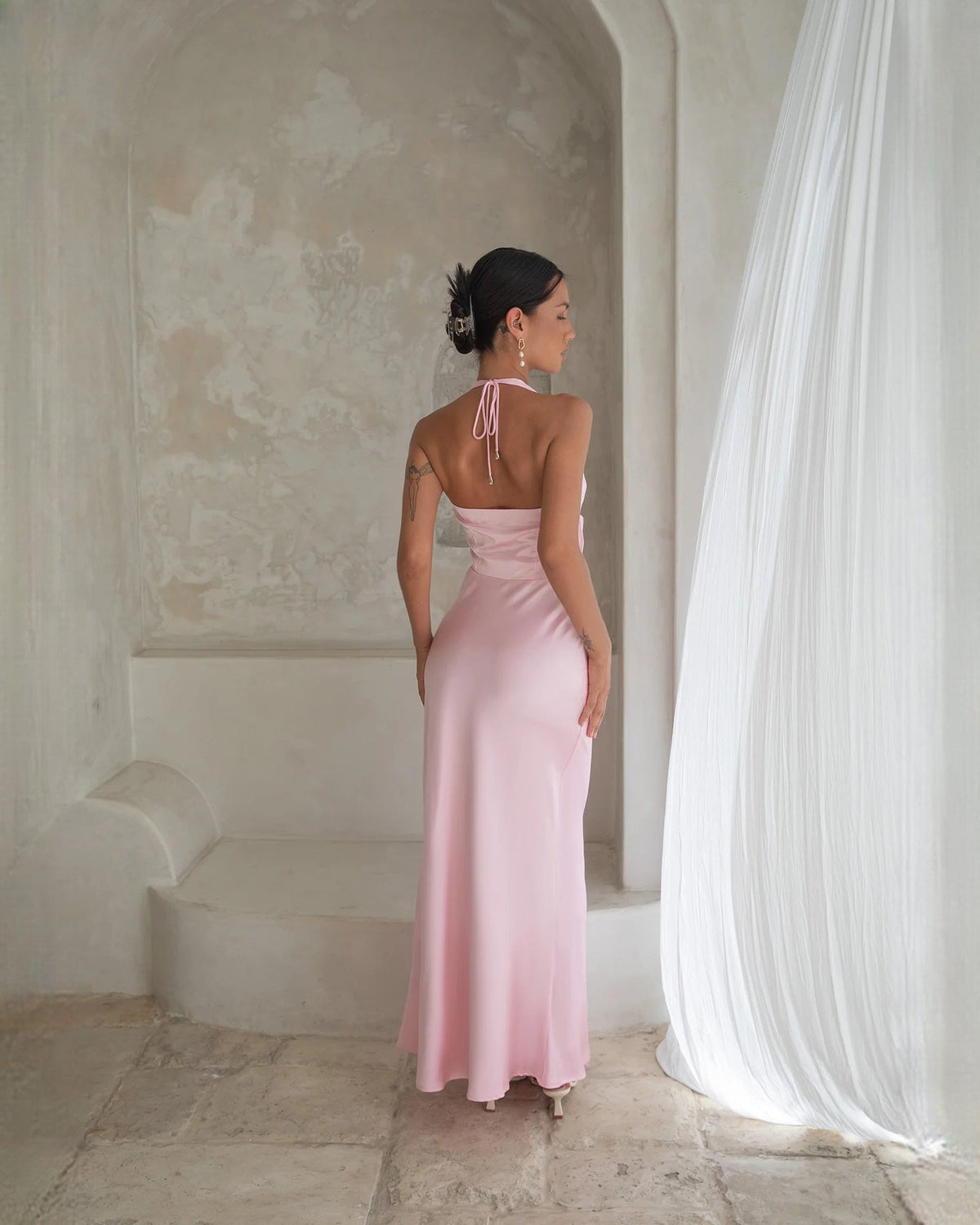 Pale pink satin halter A-line maxi dress with open back and thin tie straps