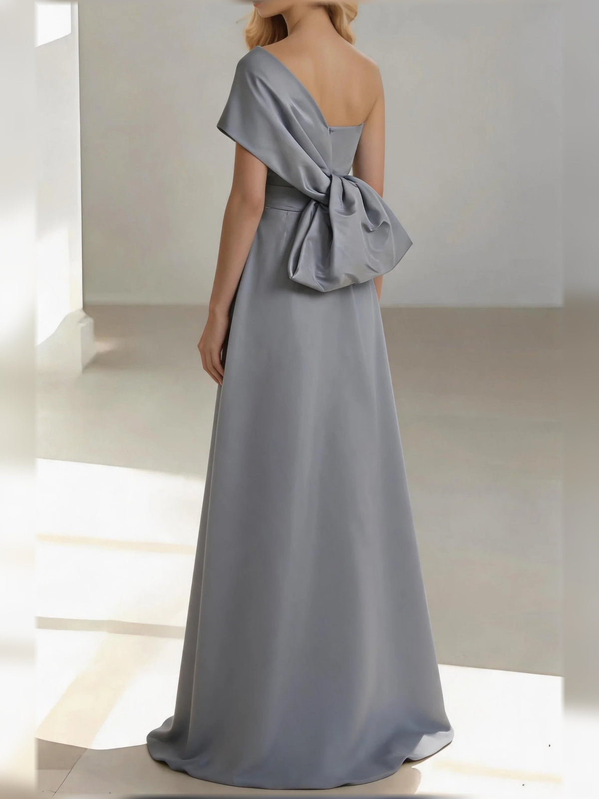 Silver one-shoulder satin mermaid floor-length gown with draped bow at shoulder
