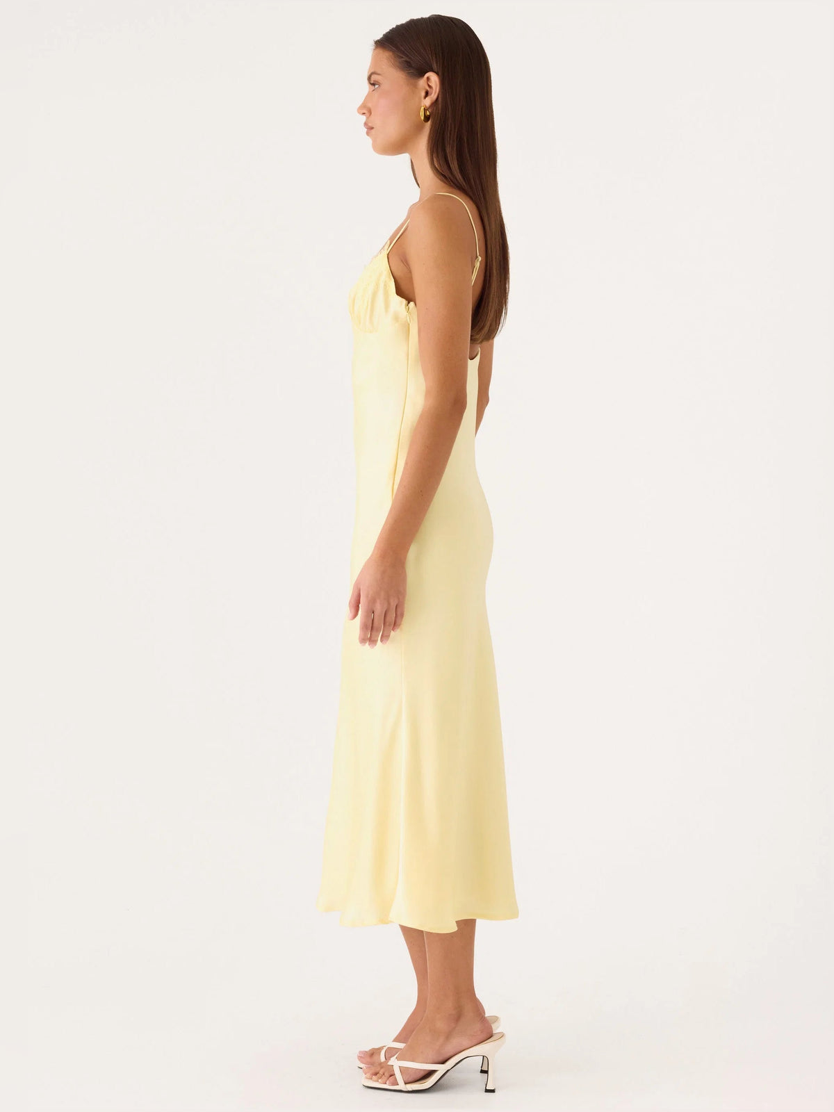 Yellow midi formal dress, side view, lace-trim bodice and fitted skirt