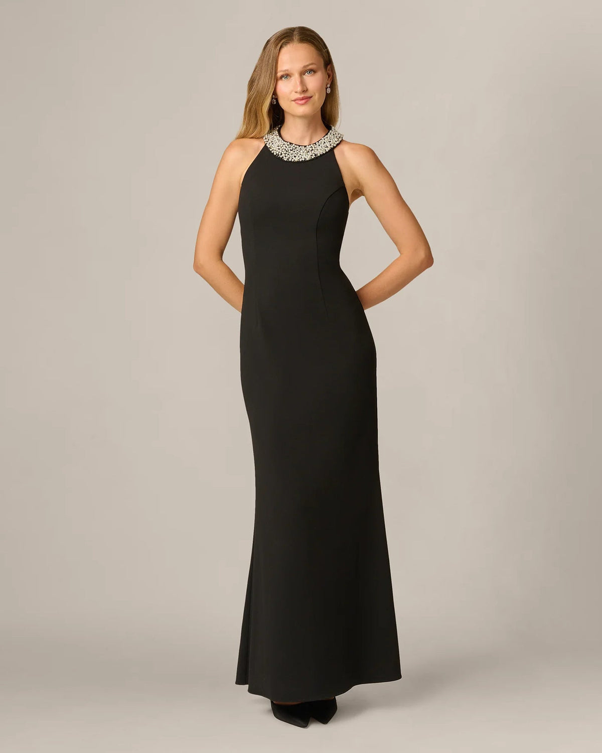 Black sleeveless halter maxi dress with rhinestone collar detail and long fitted silhouette