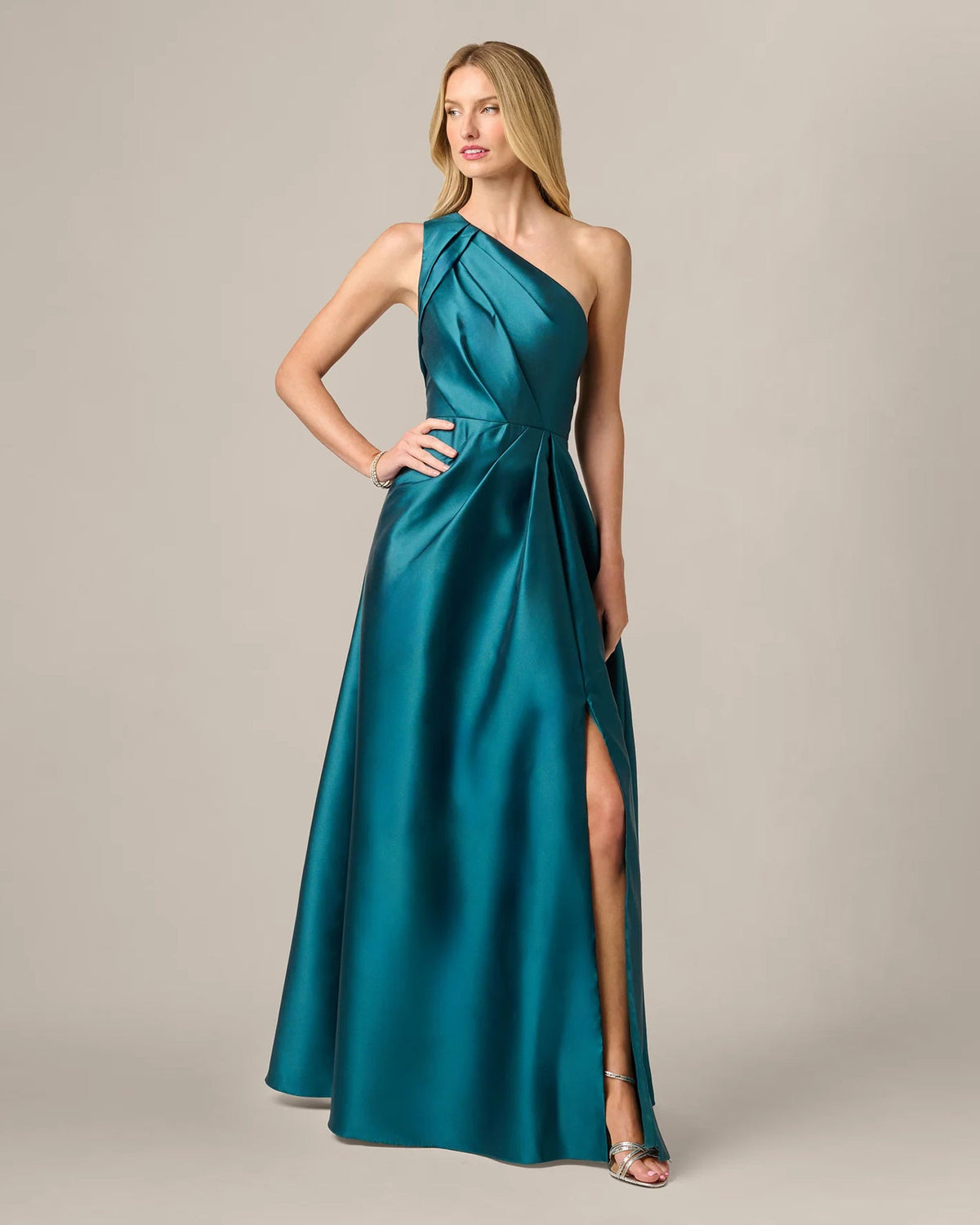 Teal one-shoulder A-line maxi dress with pleated bodice and side slit detail.