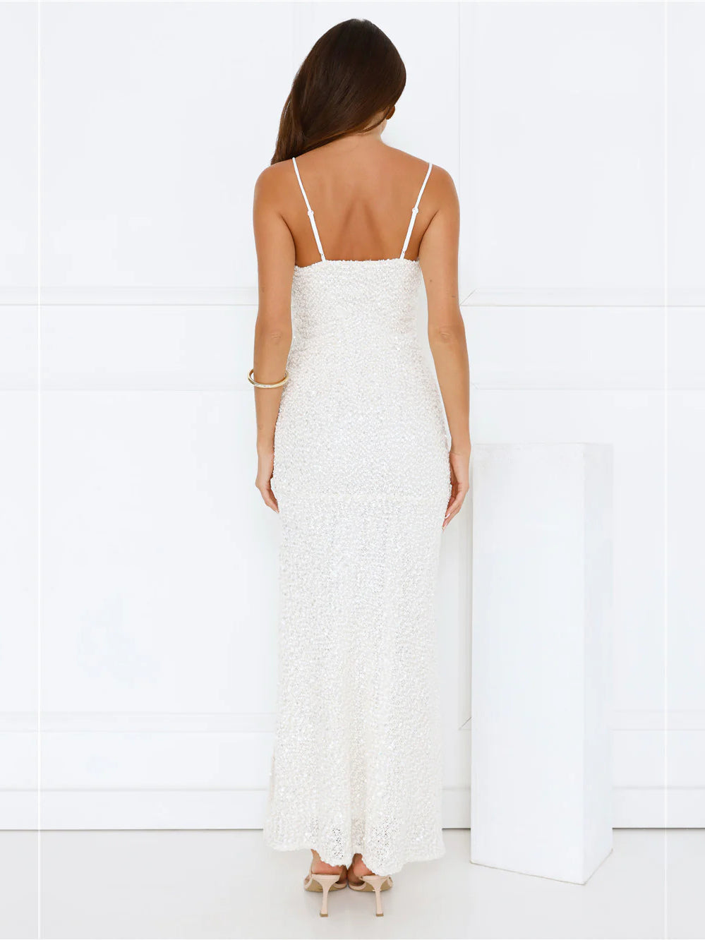 White sheath maxi formal dress with skirt slit, full-length back view