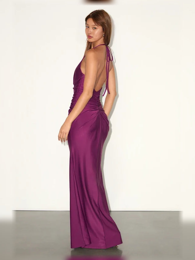 Plum halter neck formal dress with ruched side drape and floor-length silhouette