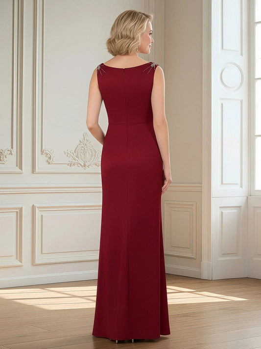 Burgundy sleeveless sheath dress with round neckline, draped floor-length skirt, back view