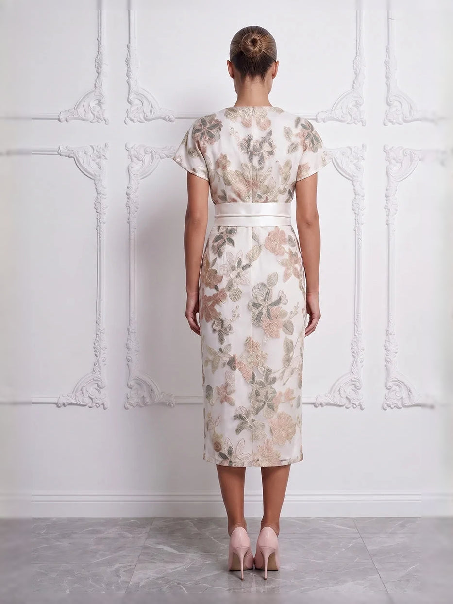 Ivory floral embroidered satin sheath dress, boat neck, back view with waist bow