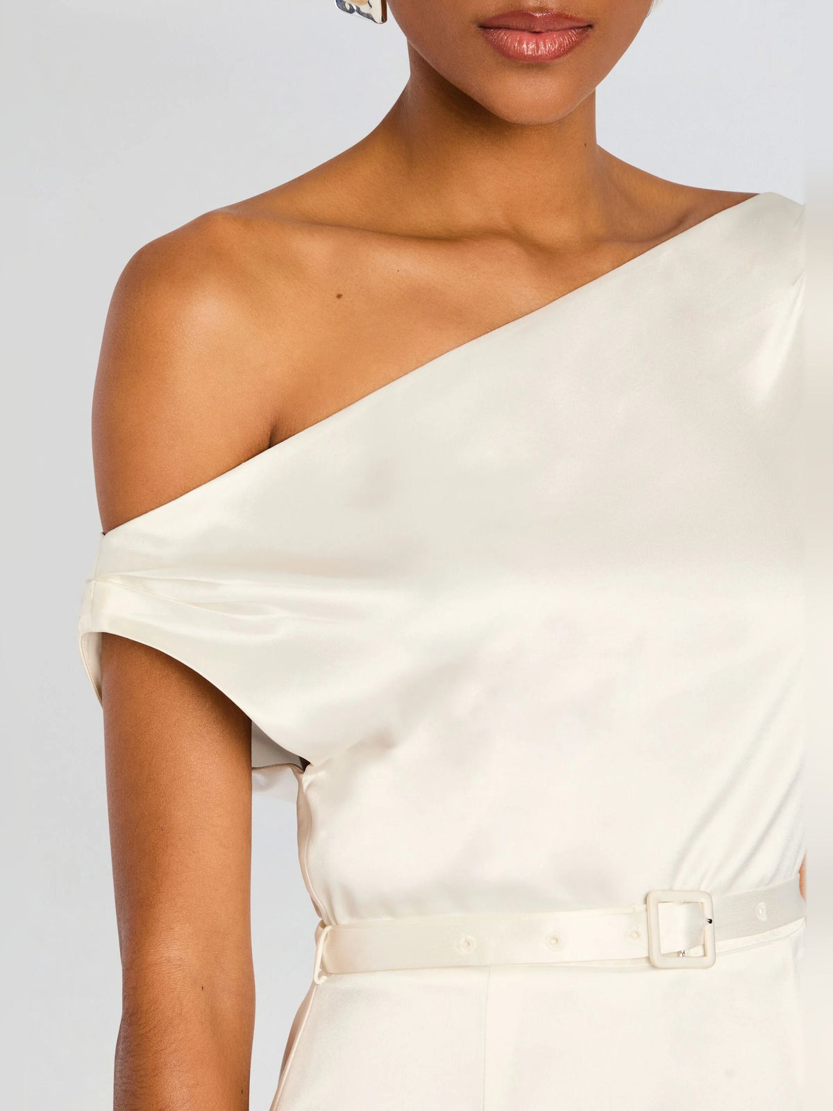 White satin mini dress with draped off-shoulder neckline and belt detail, close-up