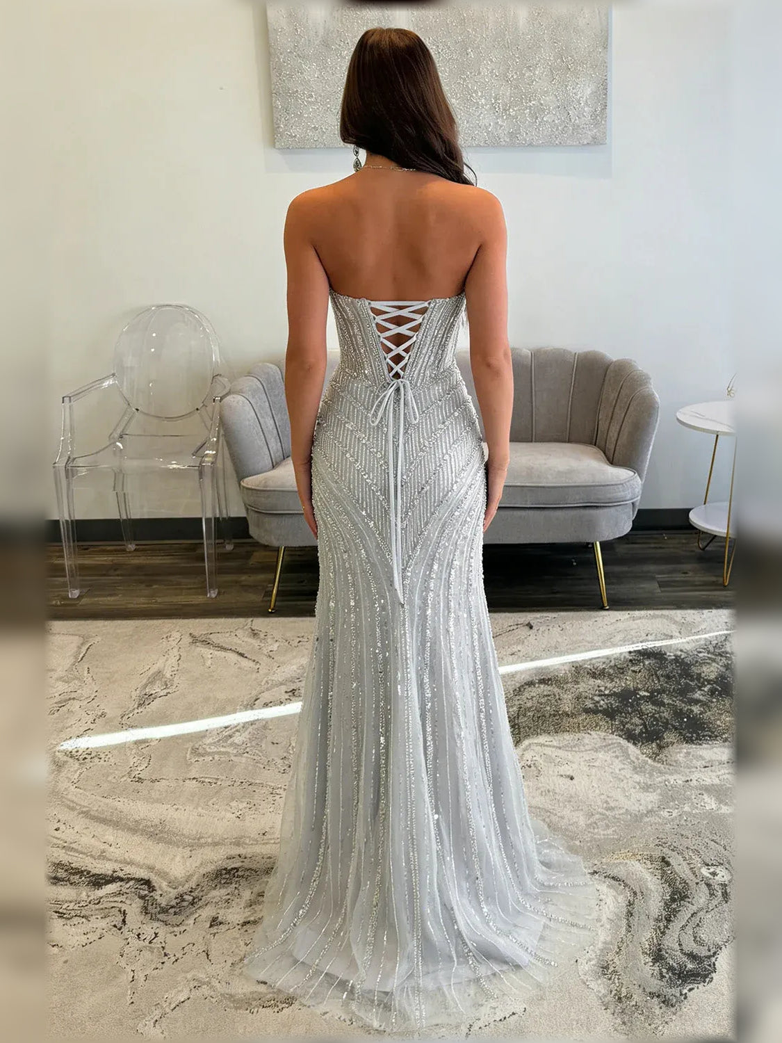 Silver beaded corset slit formal dress with crisscross low back, floor-length.