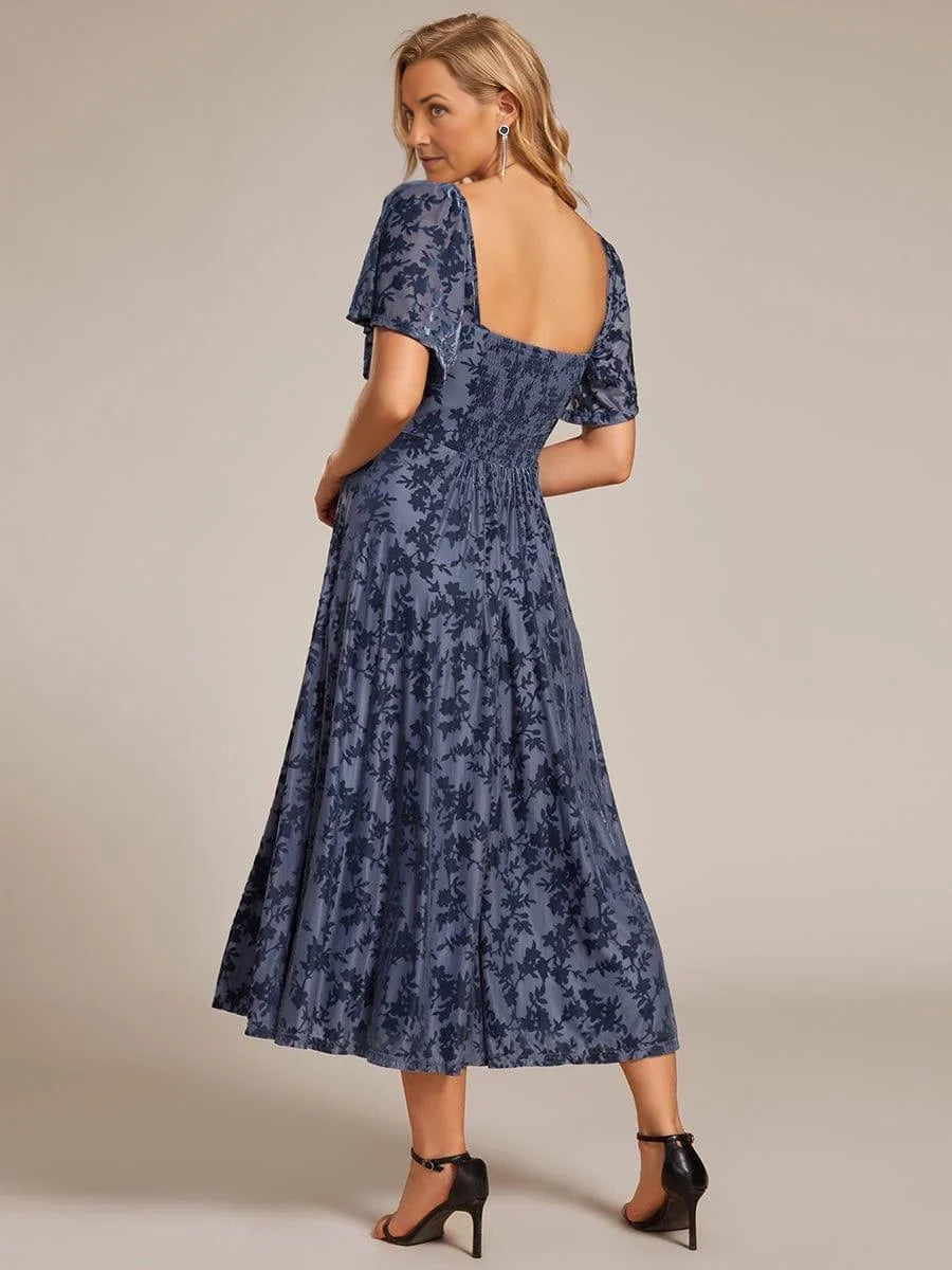 Navy blue A-line midi dress with open back and short puff sleeves