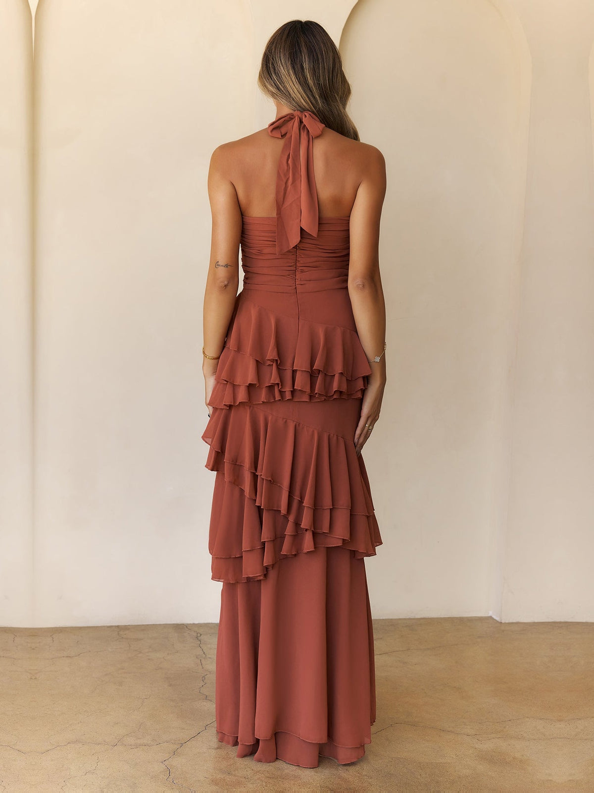 Rust a-line maxi formal dress with tiered skirt, full-length back view