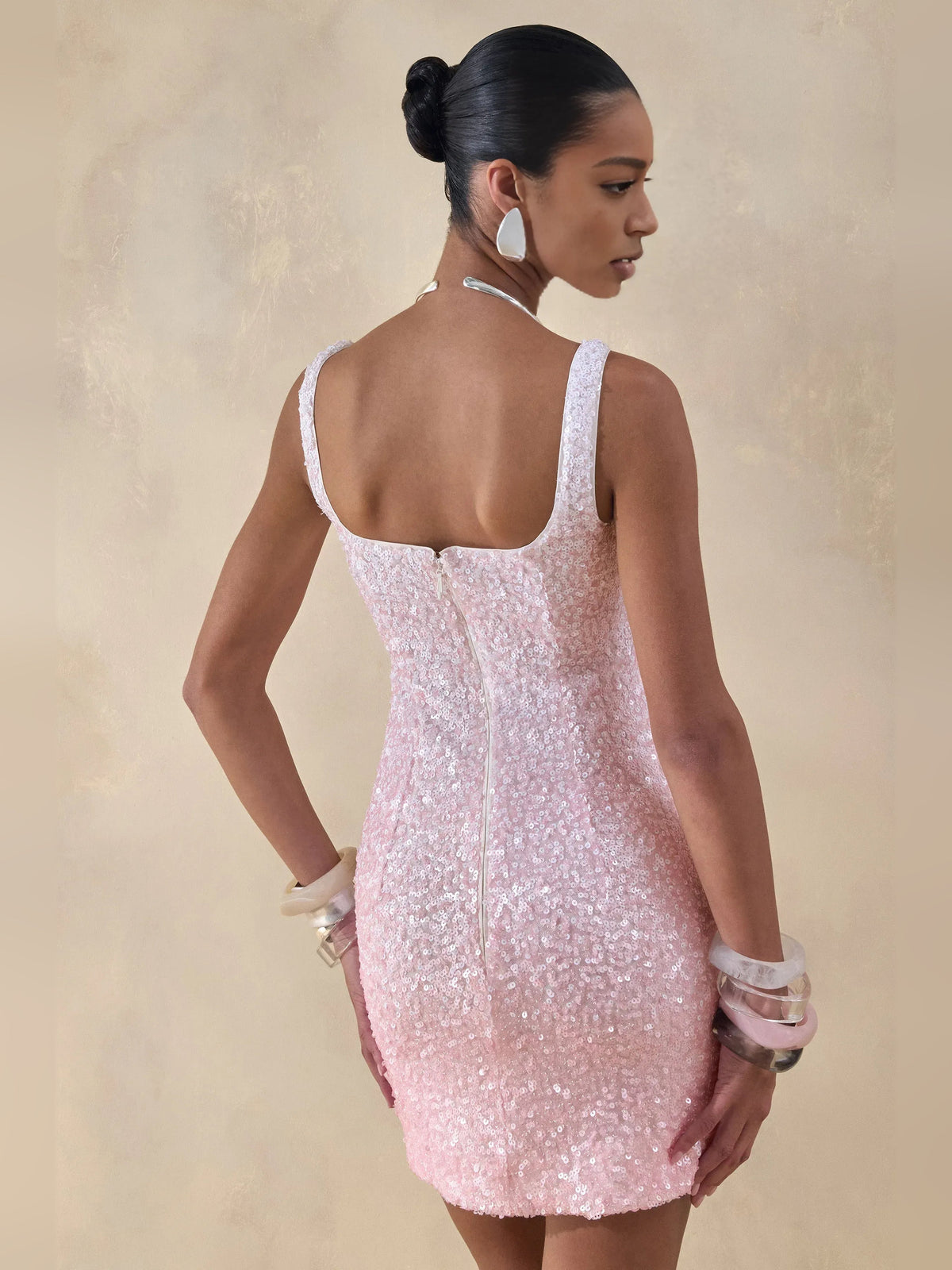 Blush pink sequin mini dress back view with wide square back and spaghetti straps