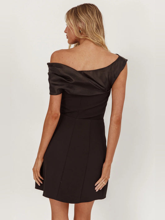 Black off-shoulder mini dress, back view with draped neckline detail