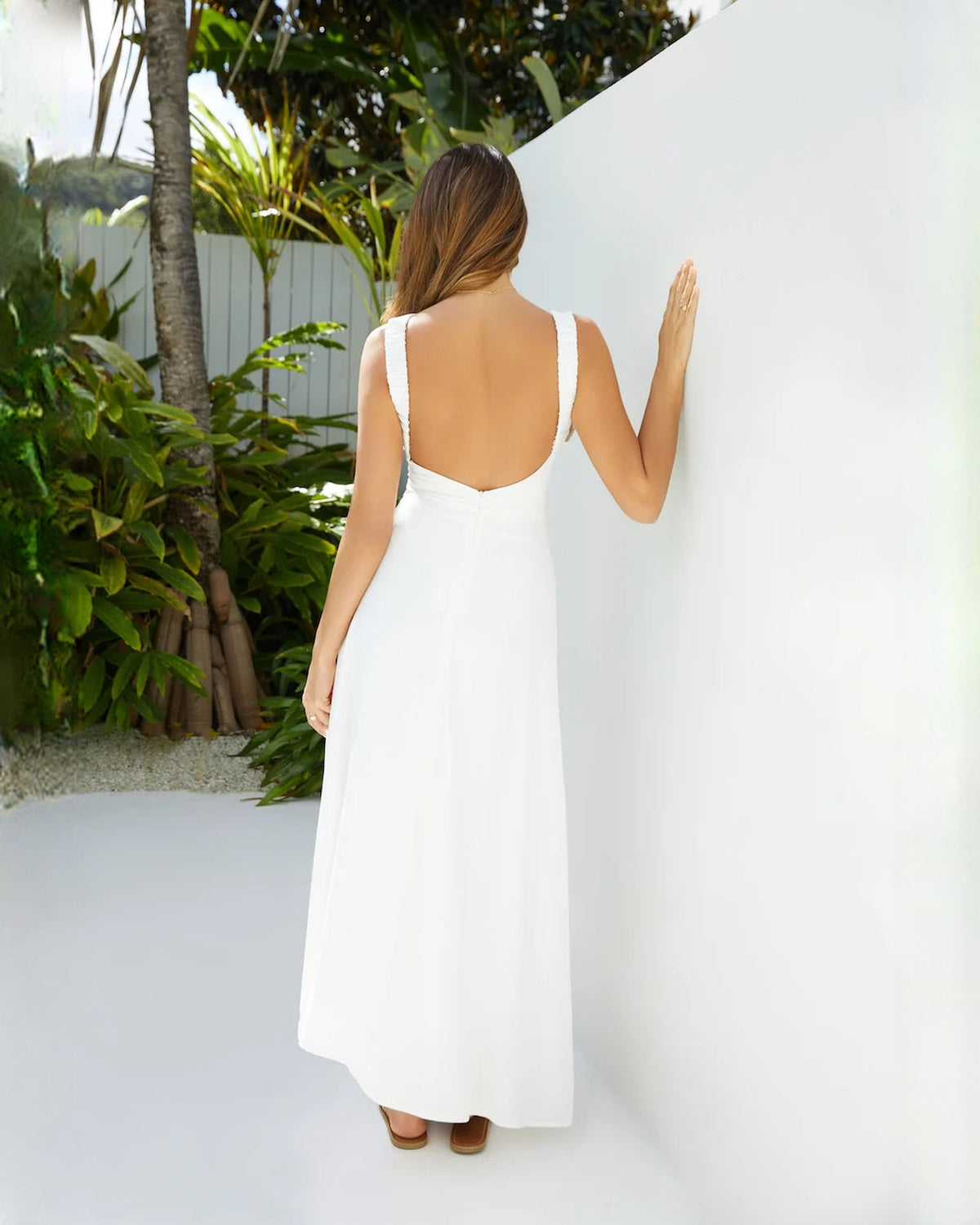 White sleeveless satin A-line maxi dress with scooped open back