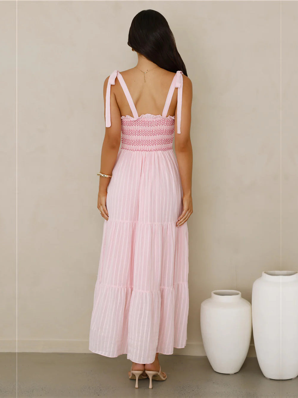 Pink a-line maxi formal dress with pleated skirt, full-length back view