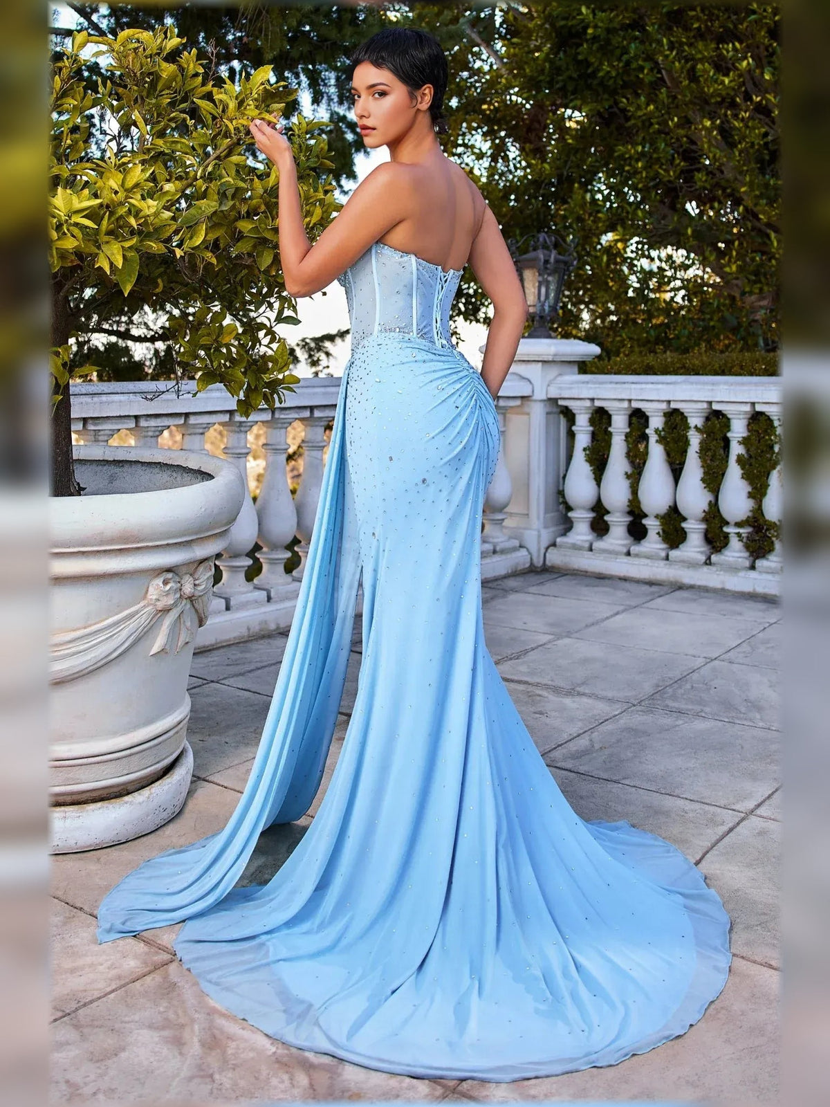 Light blue strapless rhinestone mermaid gown with ruched details and front leg slit