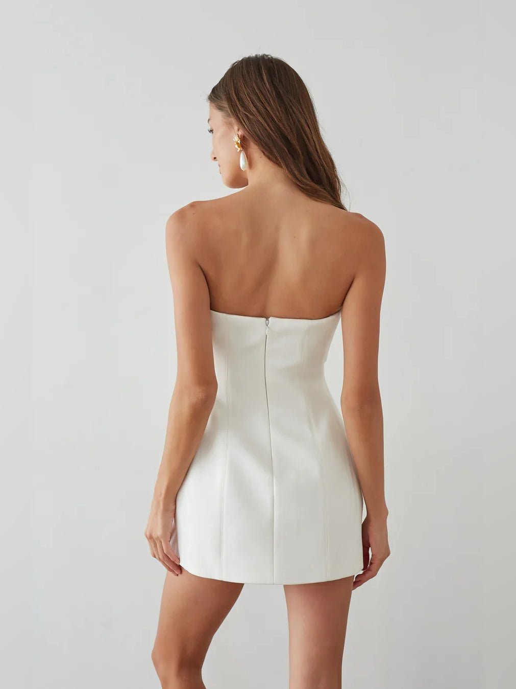 White strapless A-line mini crepe dress, back view with center seam