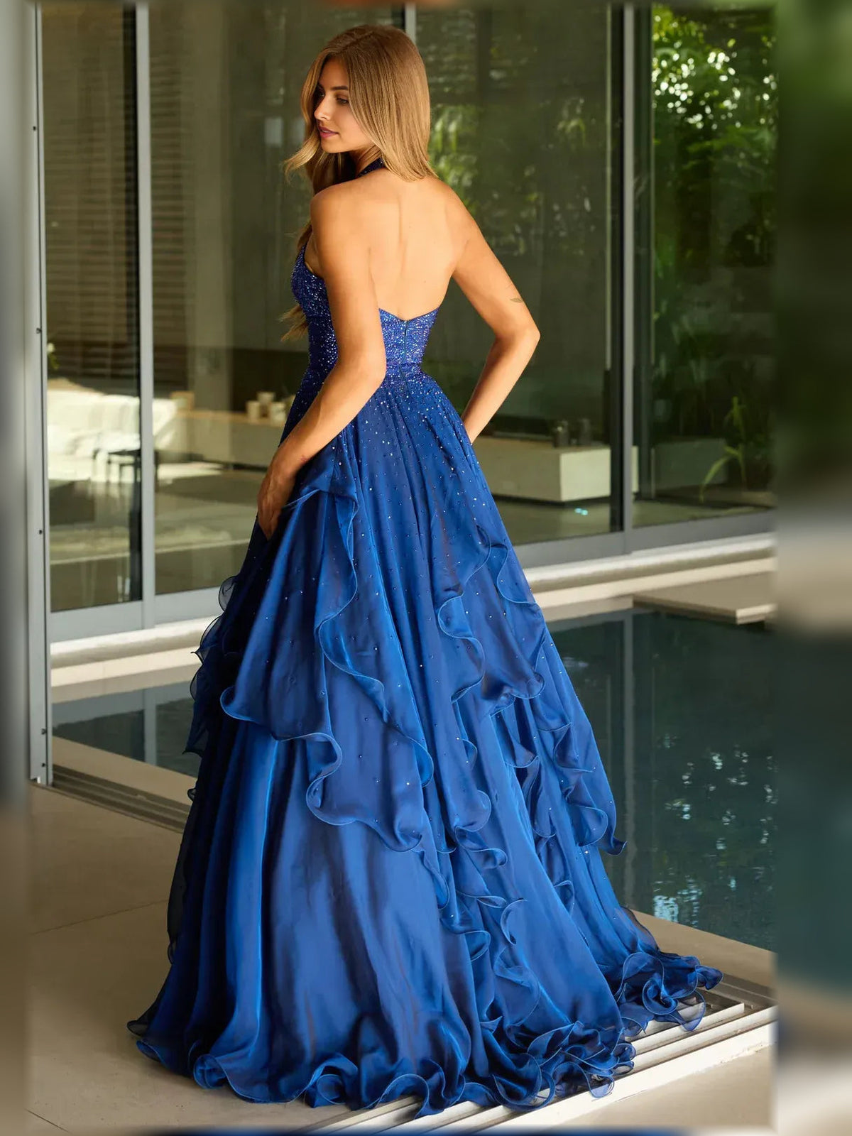 Back view of dark blue halter neck ruffle floor-length formal dress