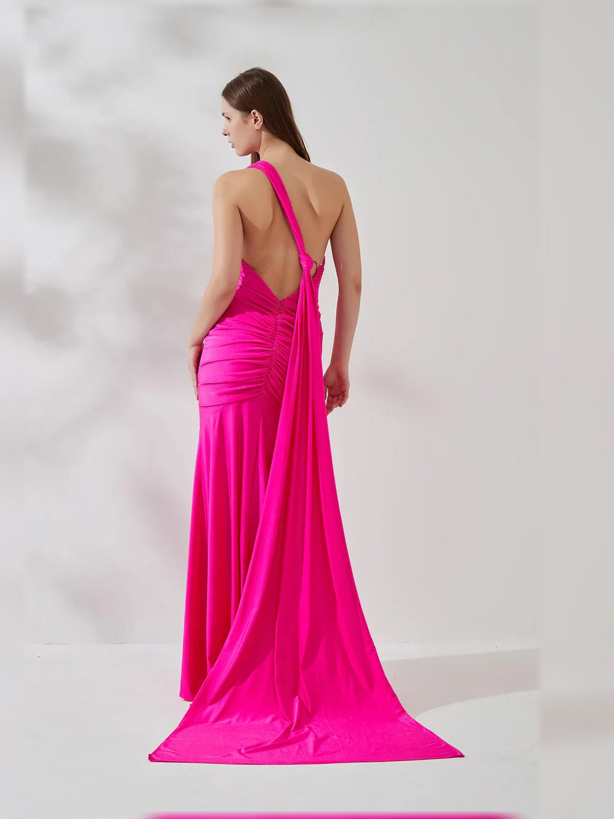 Hot pink one-shoulder mermaid gown, back view with open back detail