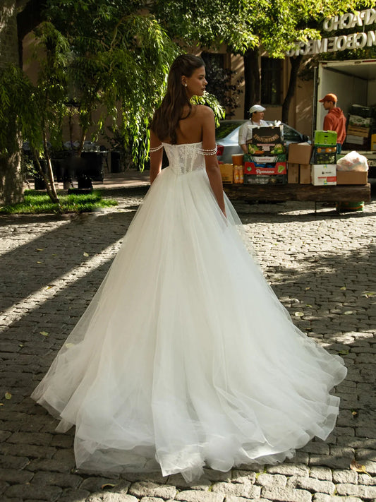 Ivory ball-gown wedding dress with lace corset back and layered tulle skirt