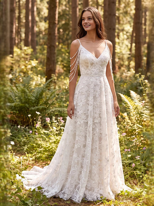 Ivory V-neck A-line wedding dress with floral applique skirt and thin spaghetti straps