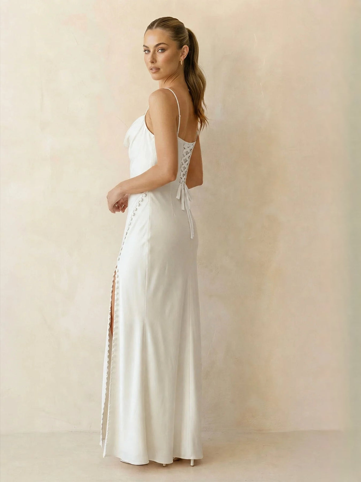 Ivory satin mermaid maxi dress with thin straps, draped corset, and side slit