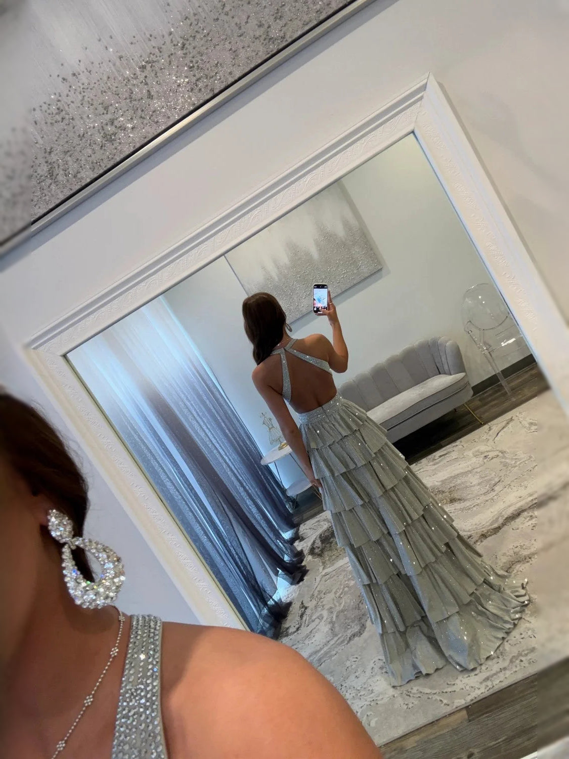 Light blue open-back tiered prom dress with beaded sparkle and low cut V back