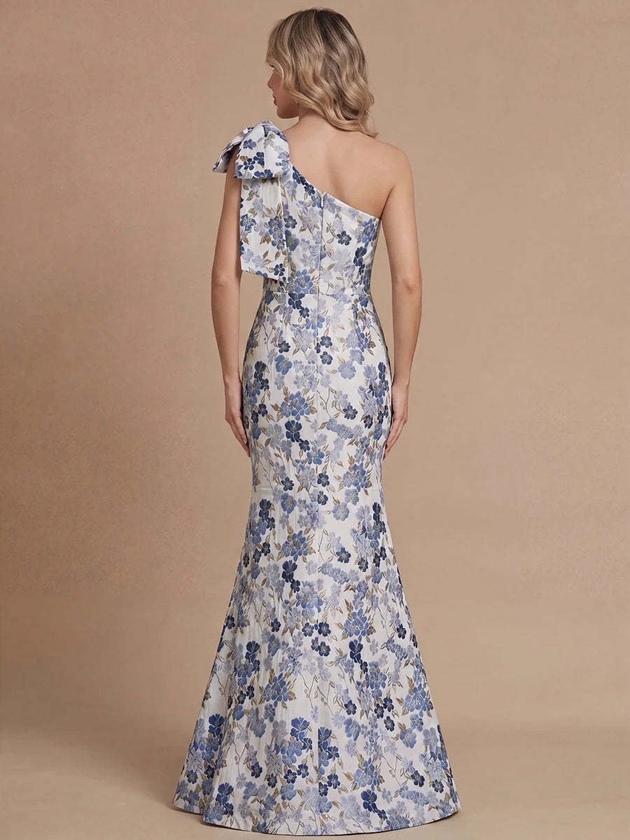 Dusty blue floral one-shoulder mermaid gown with open back and bow shoulder, floor-length