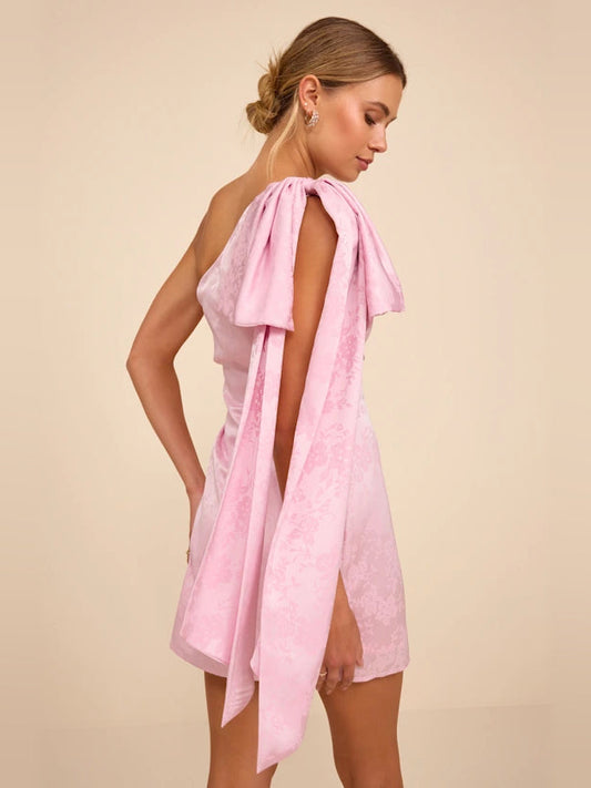 Light pink one-shoulder satin mini dress with long back bow ribbons