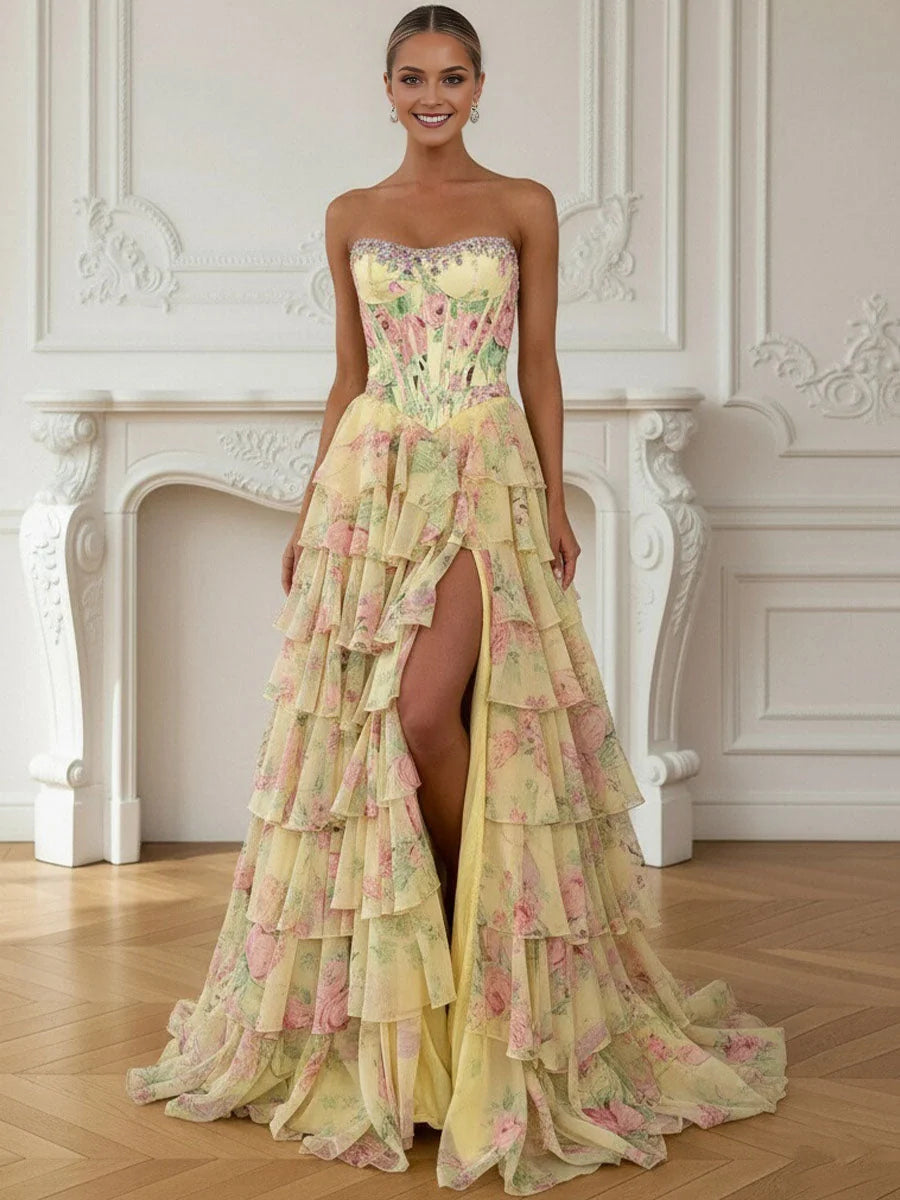 Pale lemon strapless corset prom dress with sweetheart neckline, tiered ruffle skirt and front slit