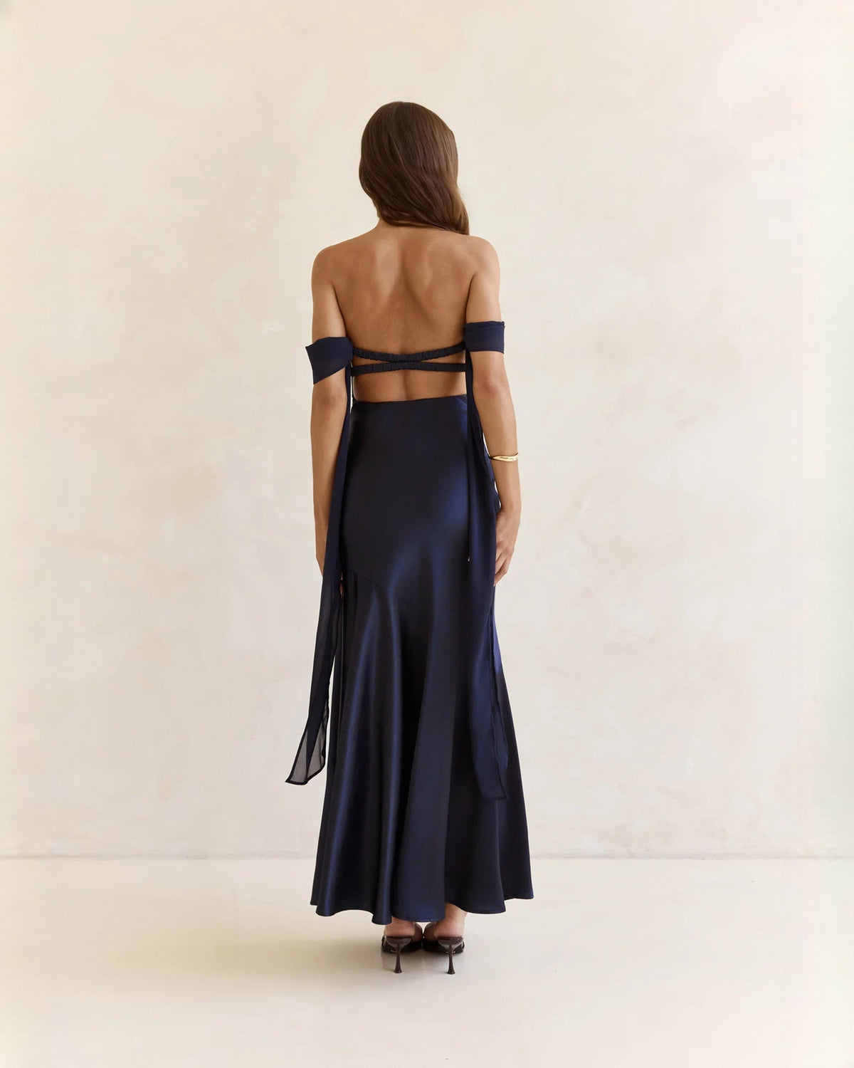 Navy satin off-shoulder A-line maxi dress with open back and crisscross straps