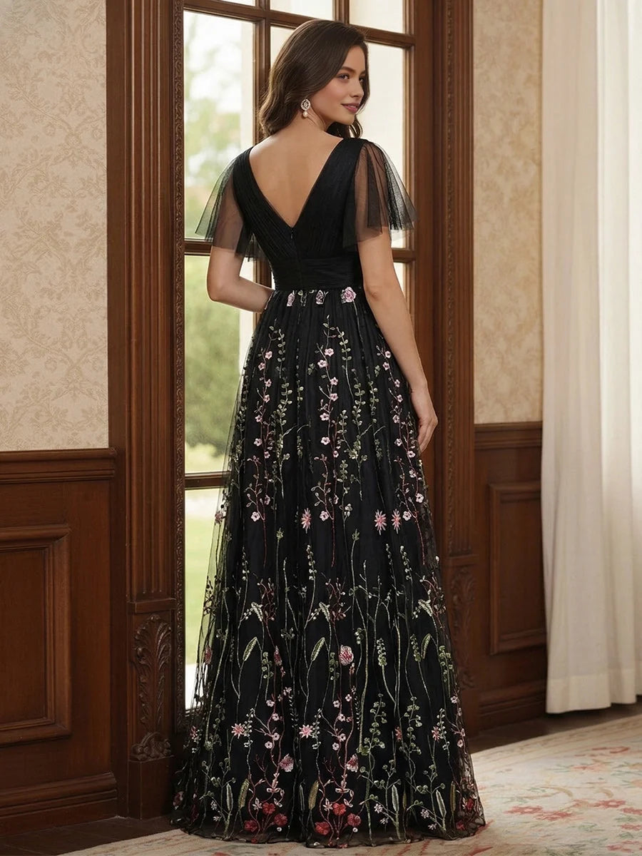 Black V-neck A-line tulle dress, back view with short sleeves and ruched waist detail