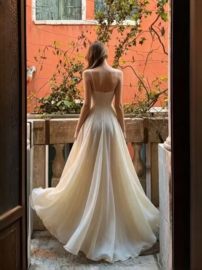 Back view of ivory sleeveless A-line prom dress with draped floor-length skirt