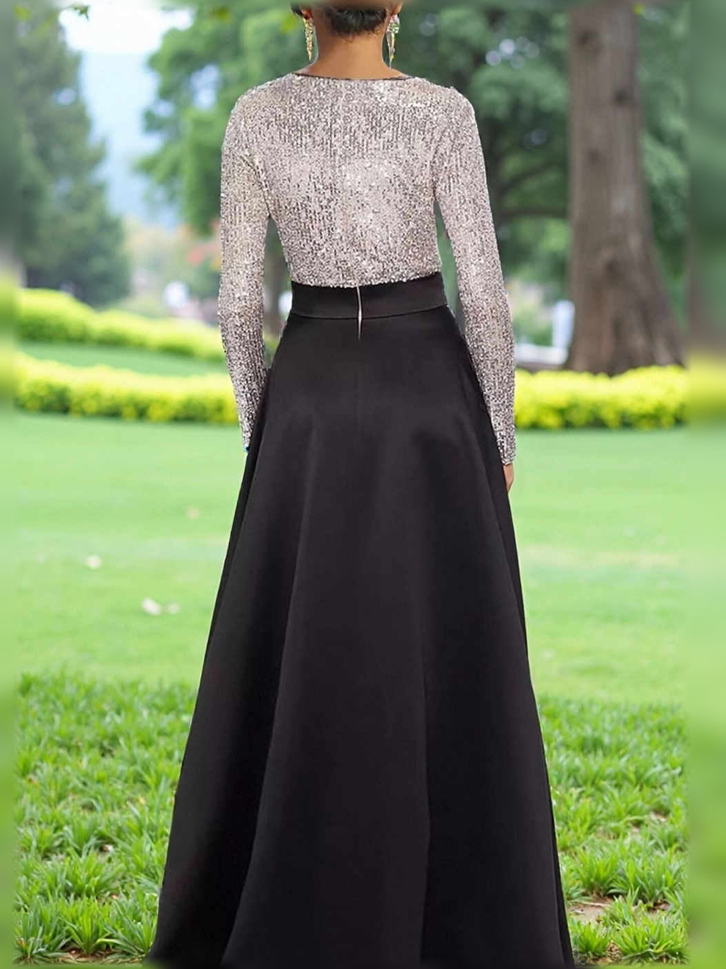 Black A-line formal dress with long-sleeve sequin bodice, satin skirt, waist bow.