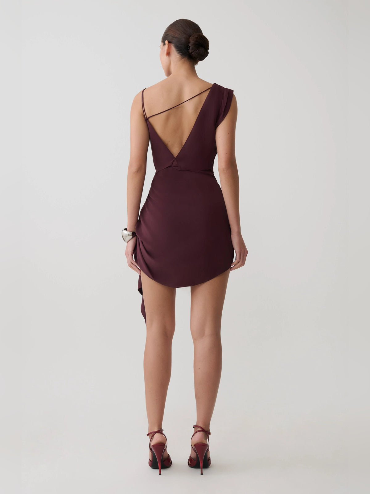 Plum satin mini homecoming dress, open back with draped cowl neckline and tied hem