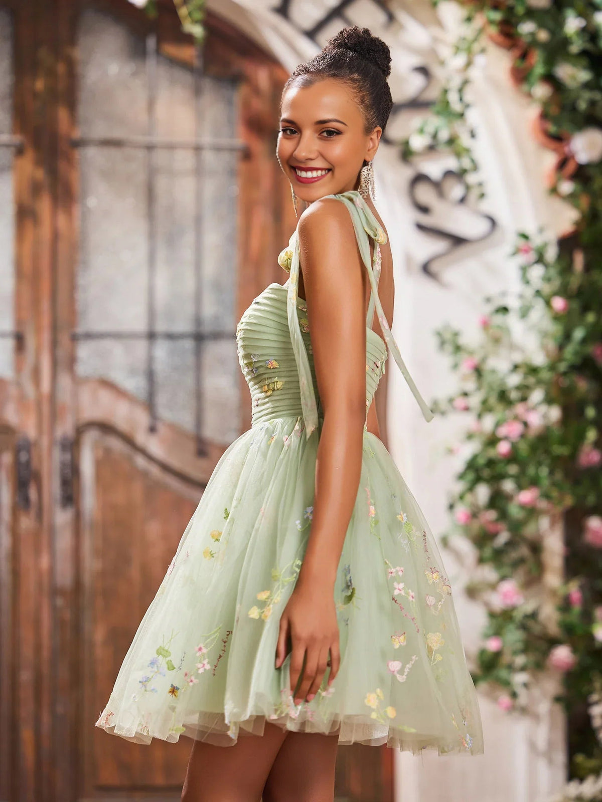 Dusty sage floral embroidered A-line mini dress, side view; tulle skirt and corset bodice
