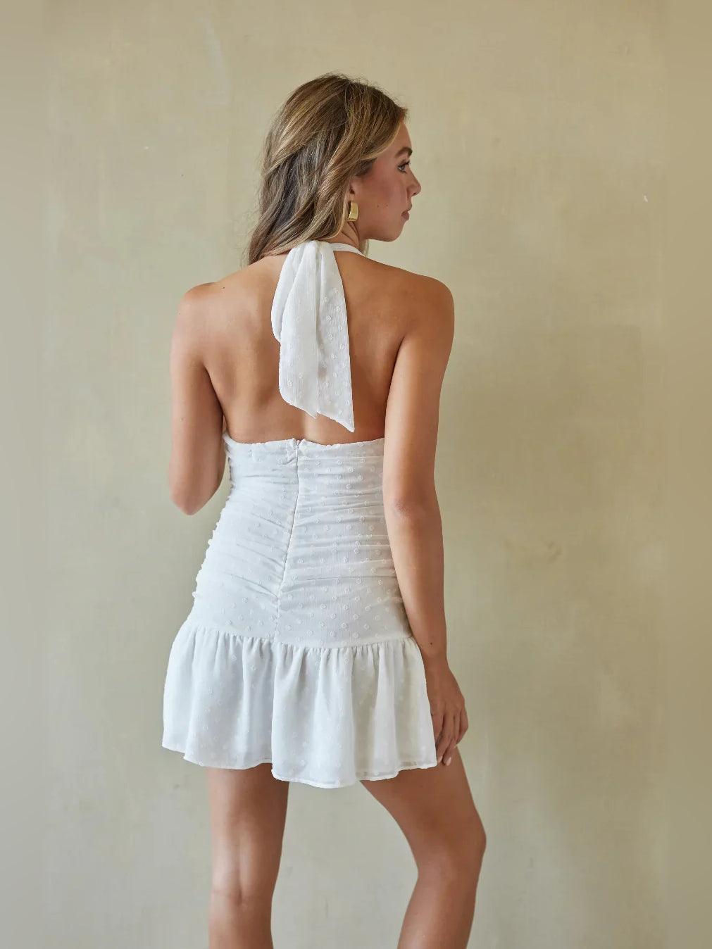 White ruched V-neck mini A-line dress with open back and ruffled tiered skirt
