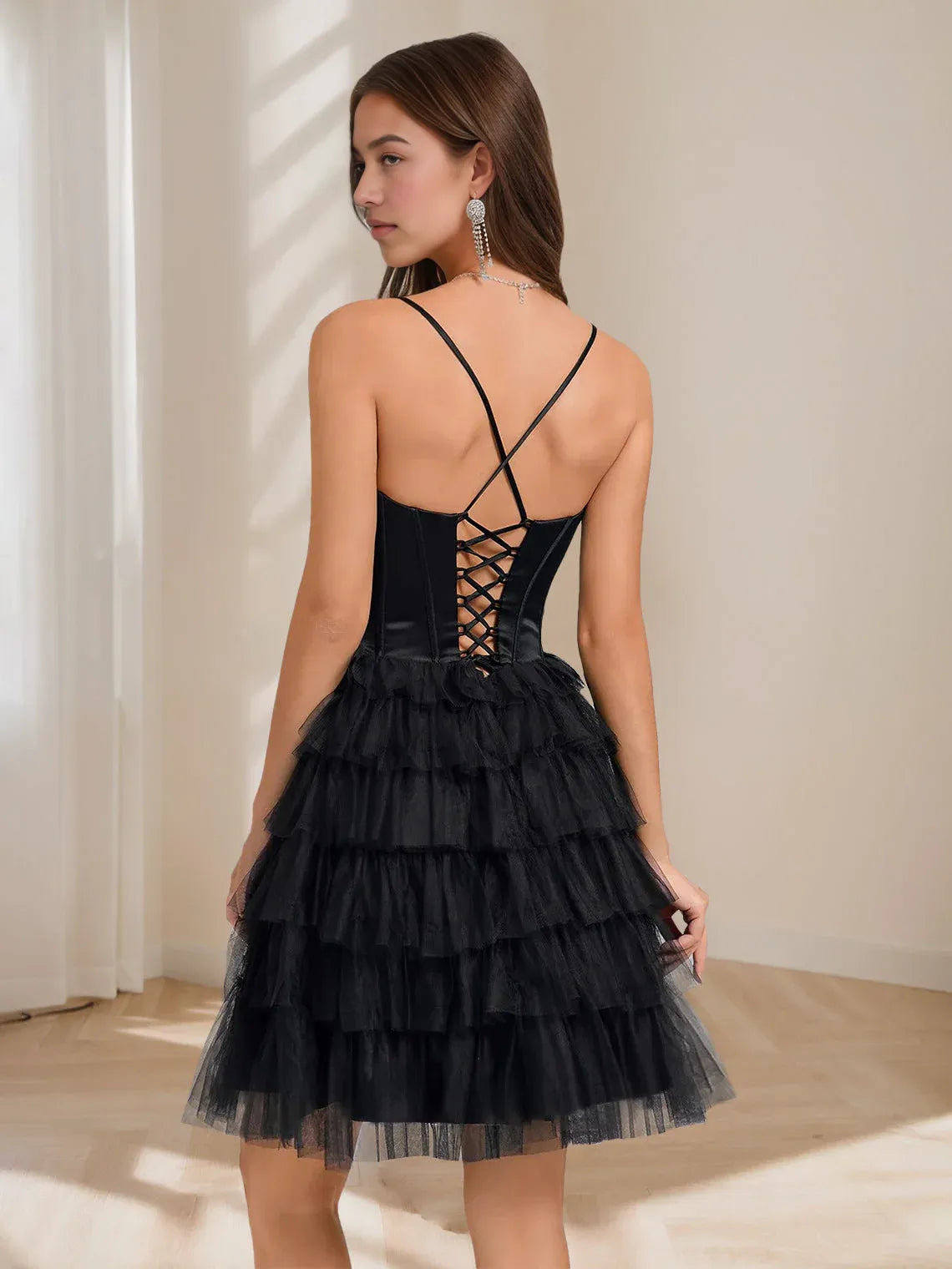 Black corset mini dress with crisscross strappy back and tiered tulle skirt