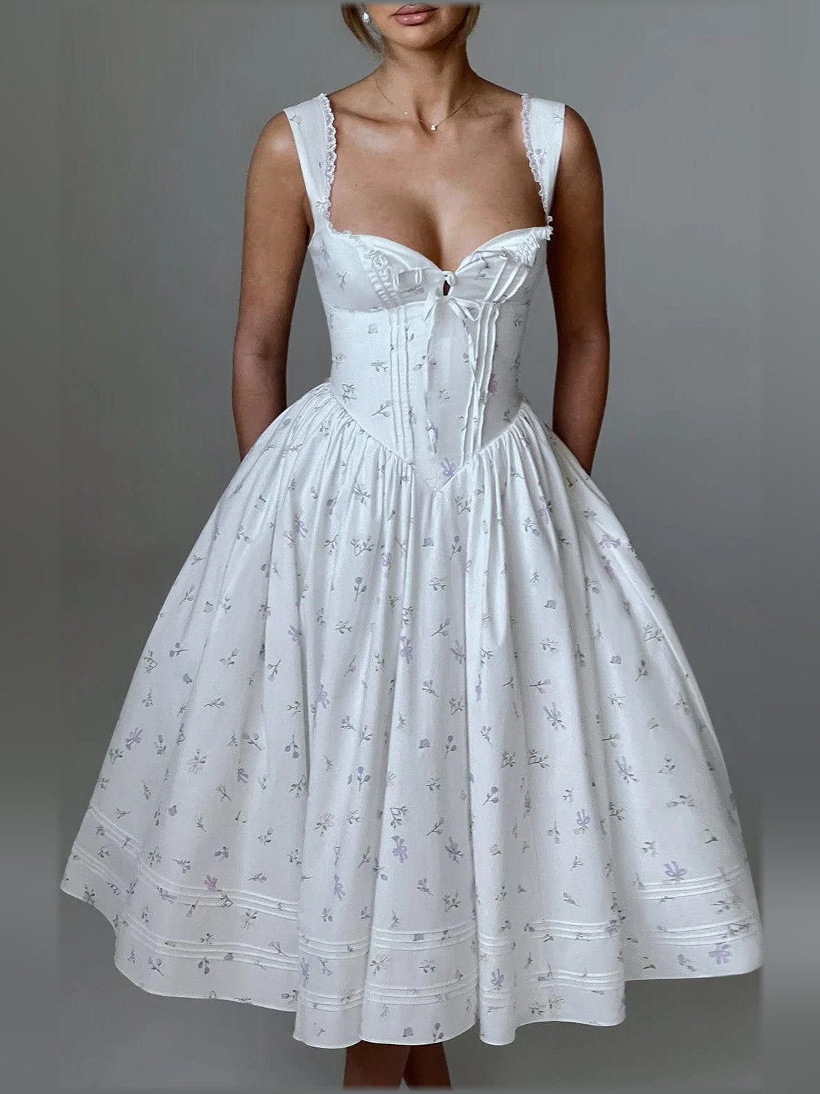 White midi formal dress with sweetheart neckline, boned corset bodice, bow tie detail, full skirt