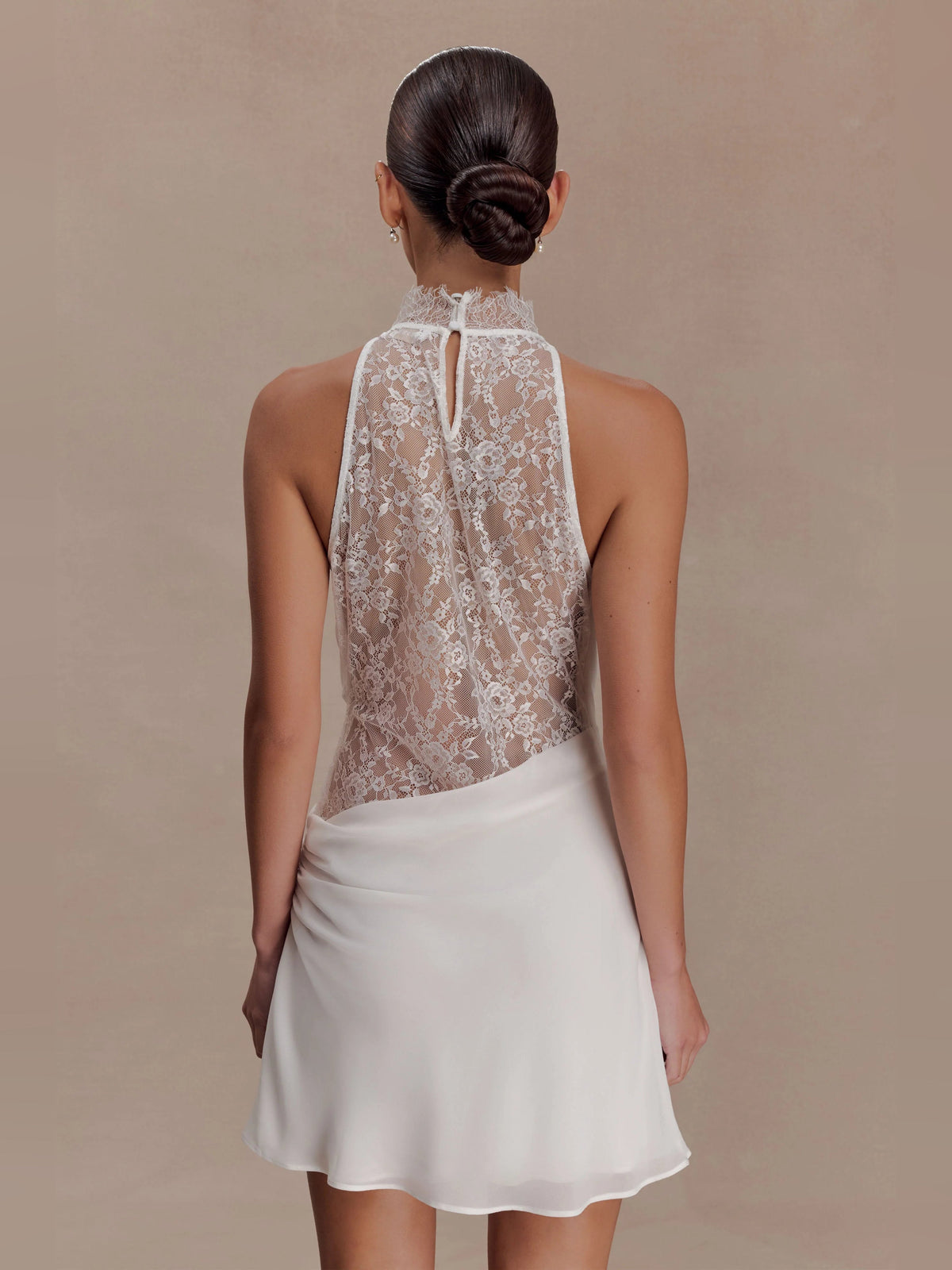 White halter-neck mini dress with lace back bodice and flowing chiffon skirt