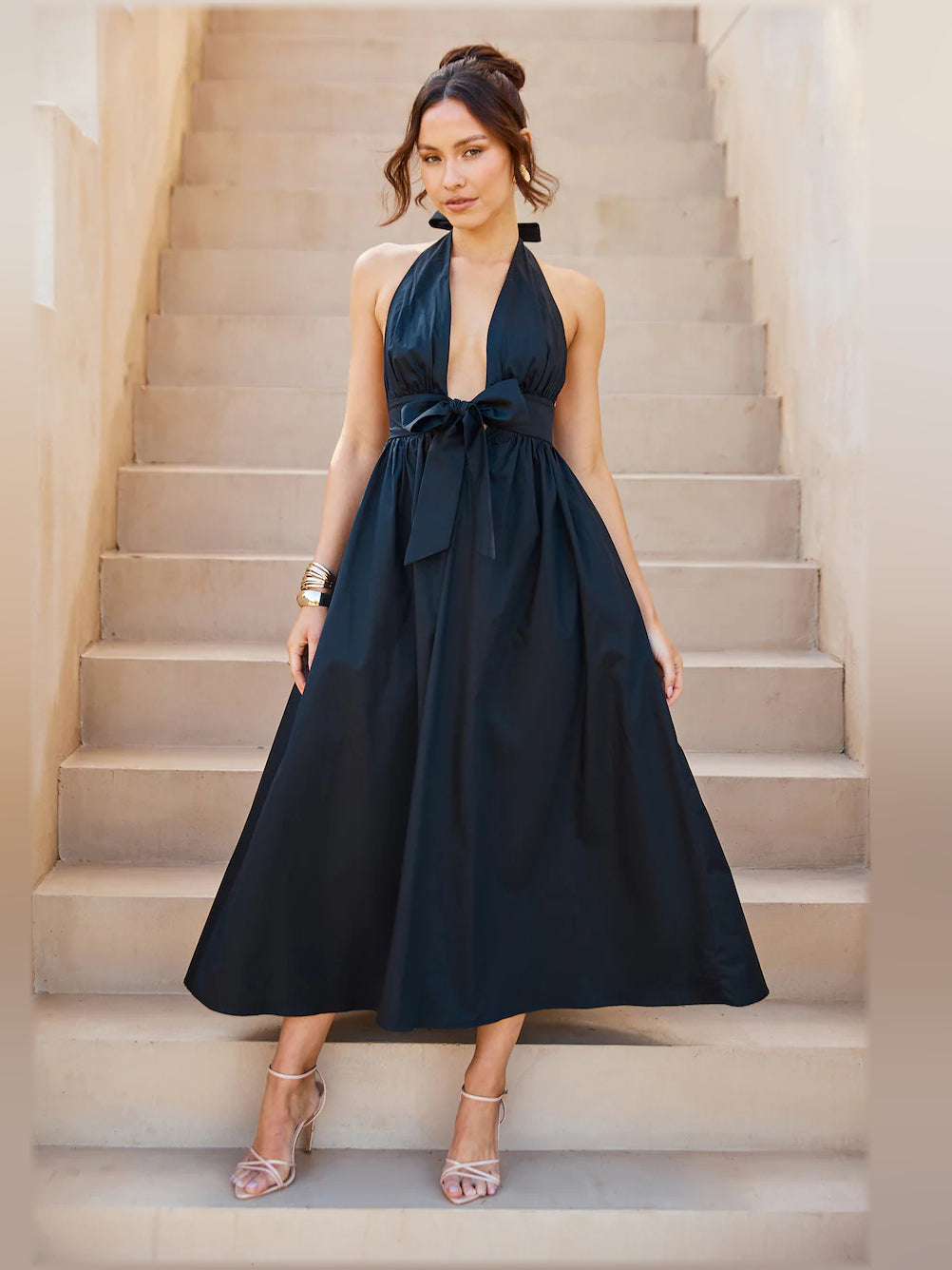 Black halter midi dress with draped halter neckline and gathered waist