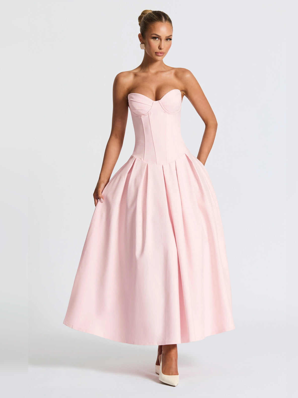 Blush pink strapless midi formal dress with corset-style bodice and full gathered skirt