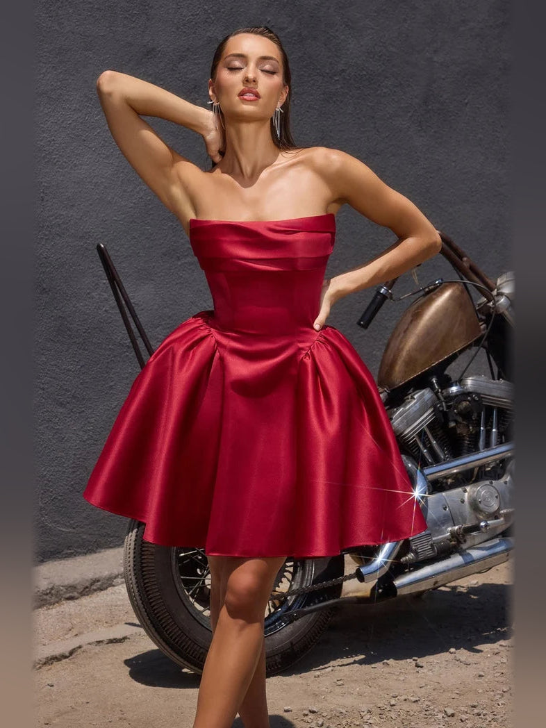 Burgundy satin pleated A-line mini dress with strapless sweetheart bodice and full skirt.
