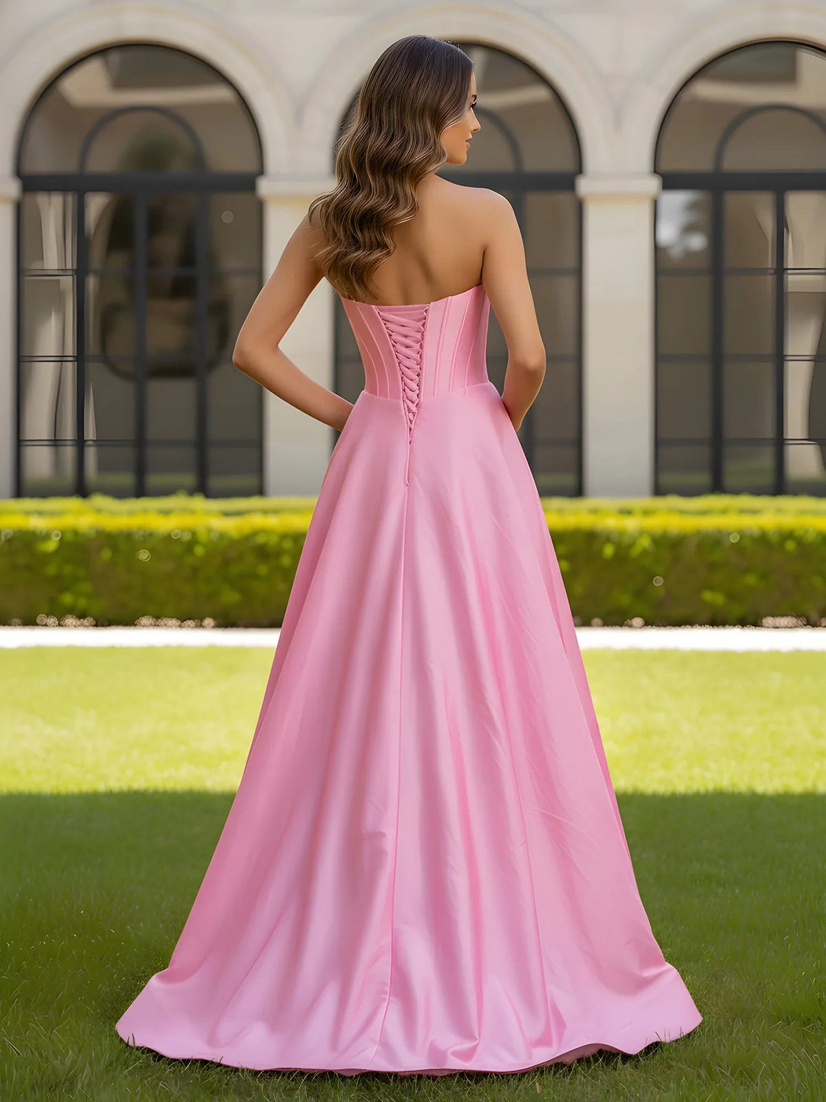 Pink strapless corset formal dress with corset back seams and floor-length skirt