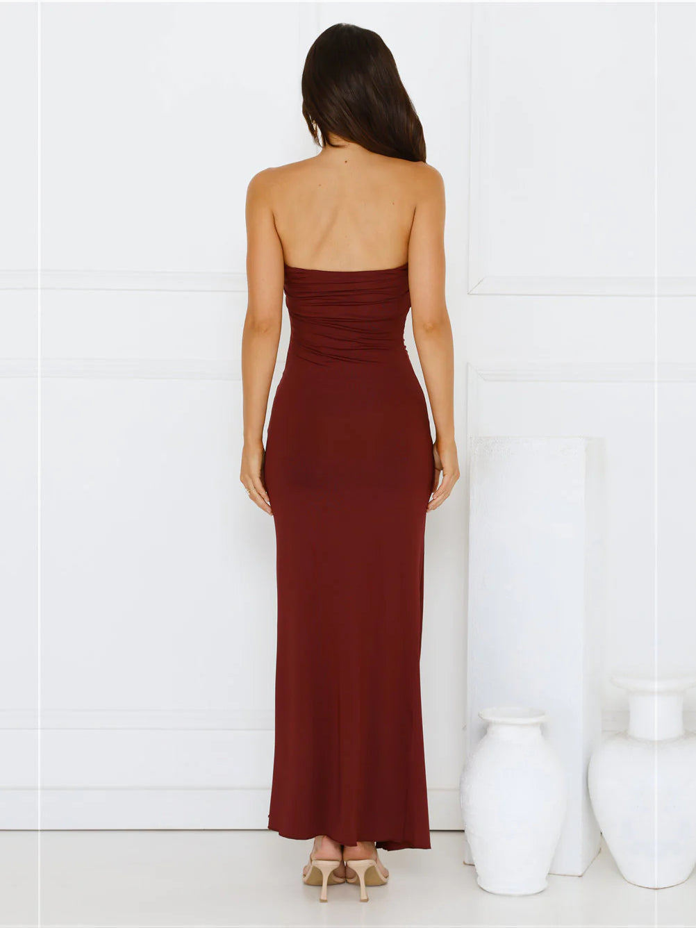 Burgundy sheath maxi formal dress with skirt slit, full-length back view