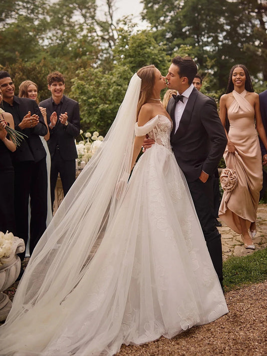 Ivory A-line wedding dress with corset bodice and long flowing tulle skirt