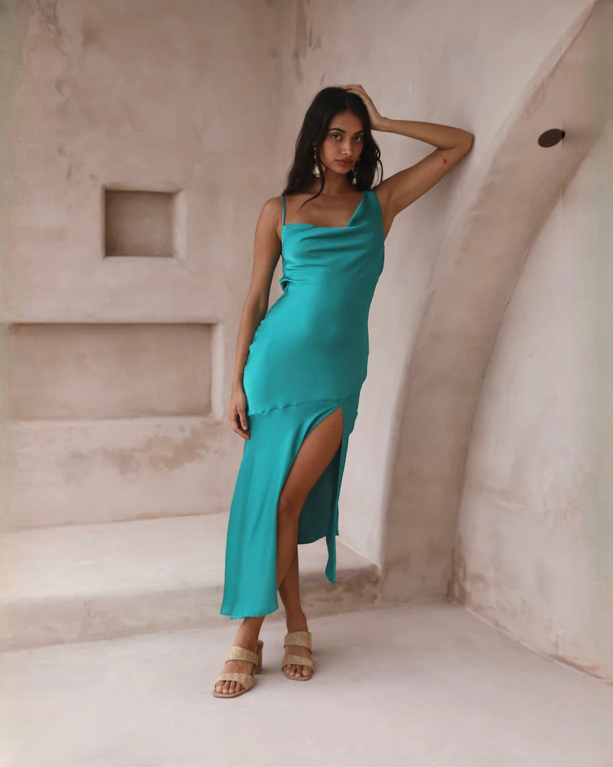 Teal satin sleeveless A-line midi dress with draped cowl front and high slit.