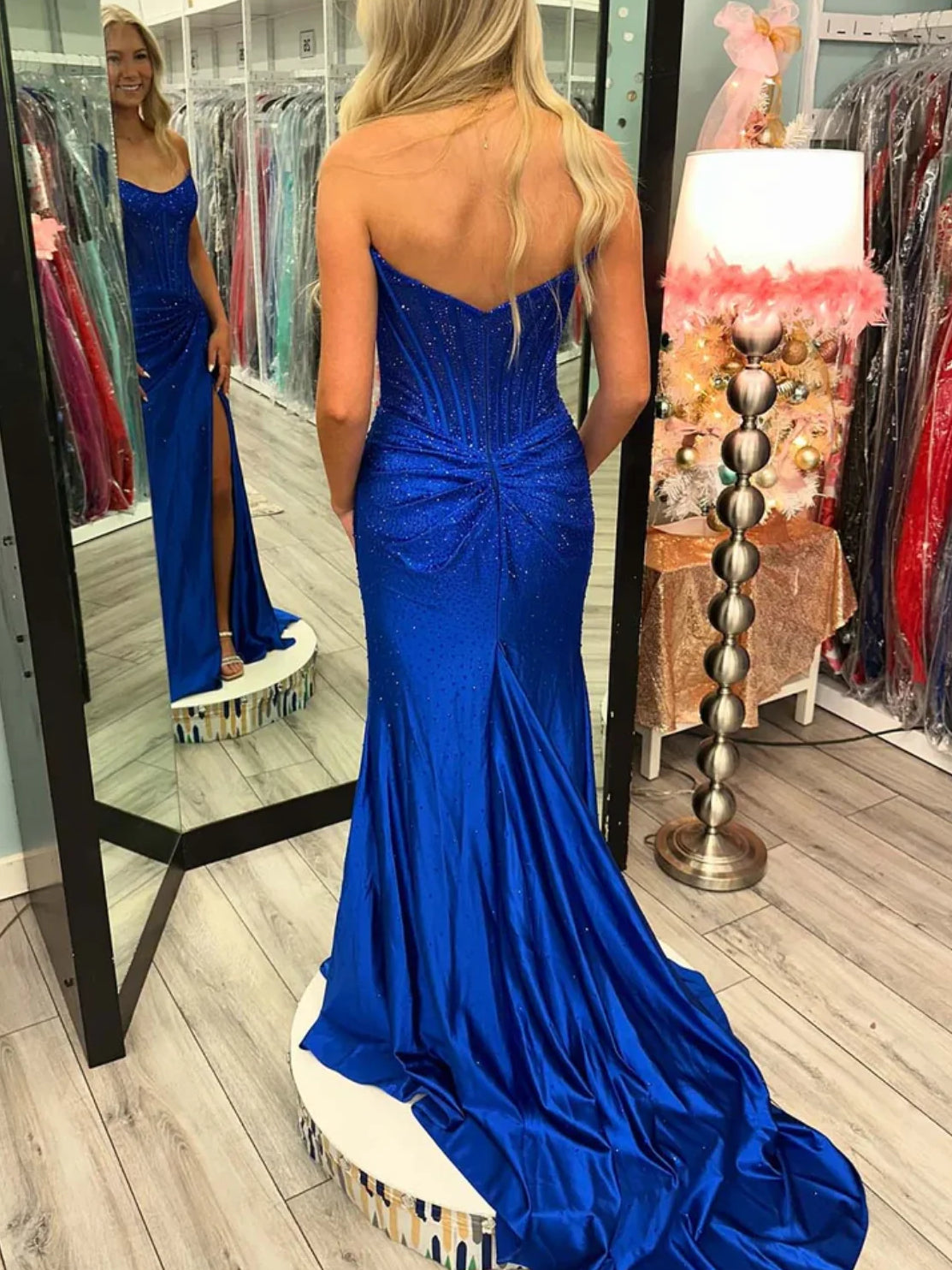 Royal blue corset-style formal dress from the back, with low back and front slit