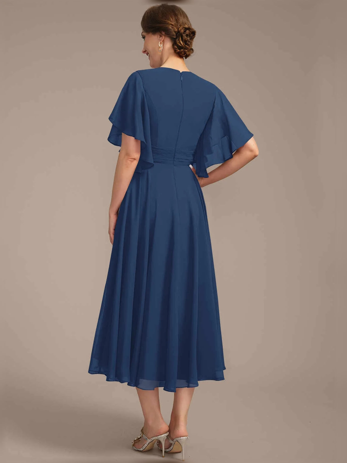 Back view of V-neck A-line chiffon dress with pleated skirt, draped waist, flutter sleeves, blue