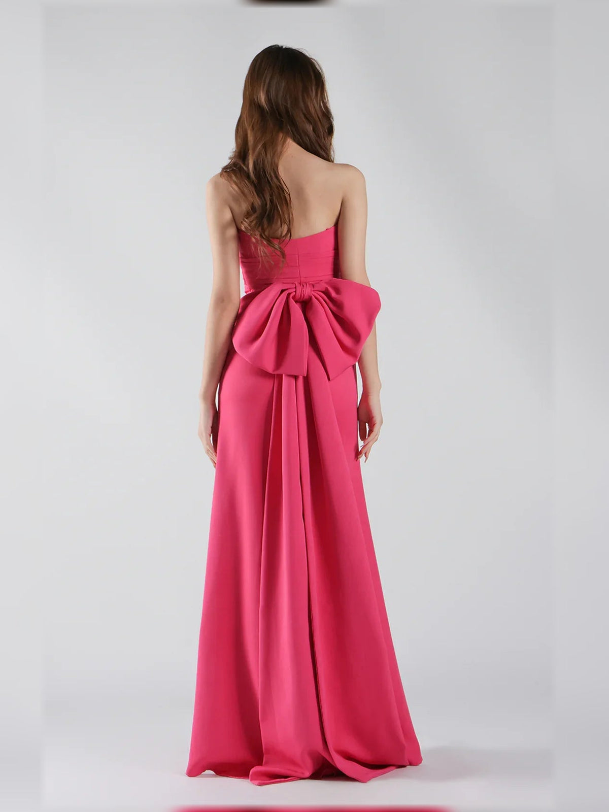 Hot pink strapless mermaid formal dress, open back with bow detail